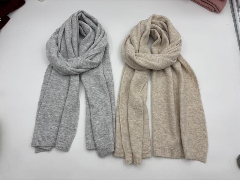 Two soft knit scarves laid flat, one light grey and one beige, with ribbed ends and cozy wrapped styling - air shipping 5-7 days arrival
