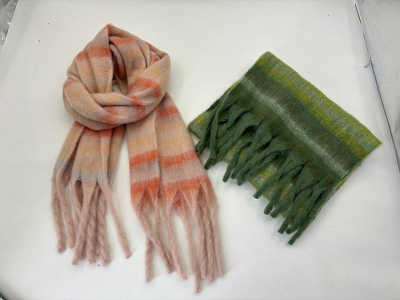 Two plush striped fringe scarves laid flat: one pink and coral, one folded in olive and lime green tones - sample order 10pcs available
