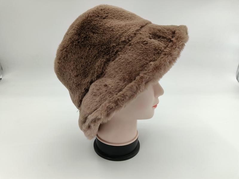 Taupe brown faux fur bucket hat displayed on a mannequin head, side view showing soft fluffy texture and wide brim - air shipping 5-7 days arrival