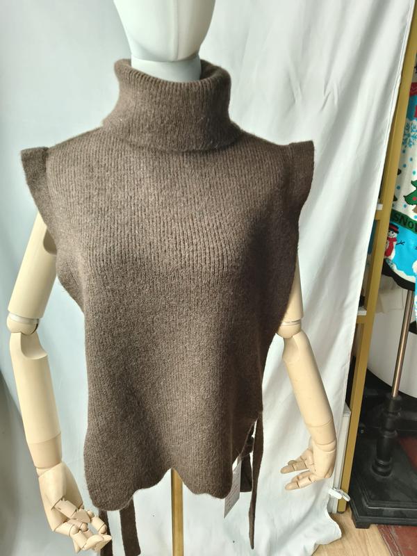 Taupe brown sleeveless turtleneck knit sweater vest with side tie details displayed on a mannequin - certified scarf manufacturer China - BSCI audit passed supplier