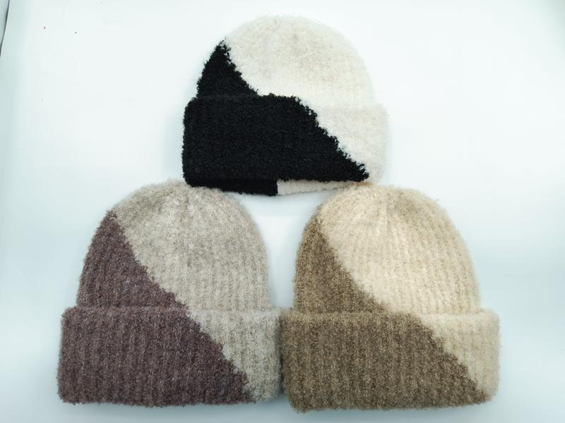 Three two-tone color block fuzzy knit beanies in black-cream, mauve-beige, and tan-cream colorways displayed on white background - custom Pantone color matching