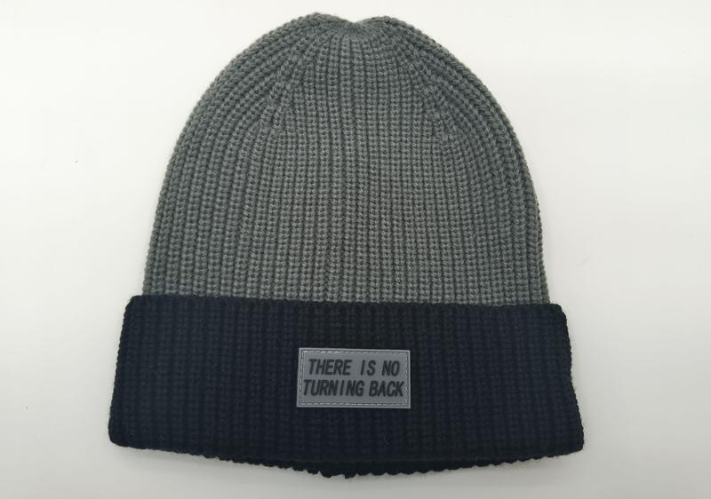 Gray and black two-tone ribbed knit winter beanie with 'There Is No Turning Back' rubber label patch on dark cuff - BSCI audit passed supplier