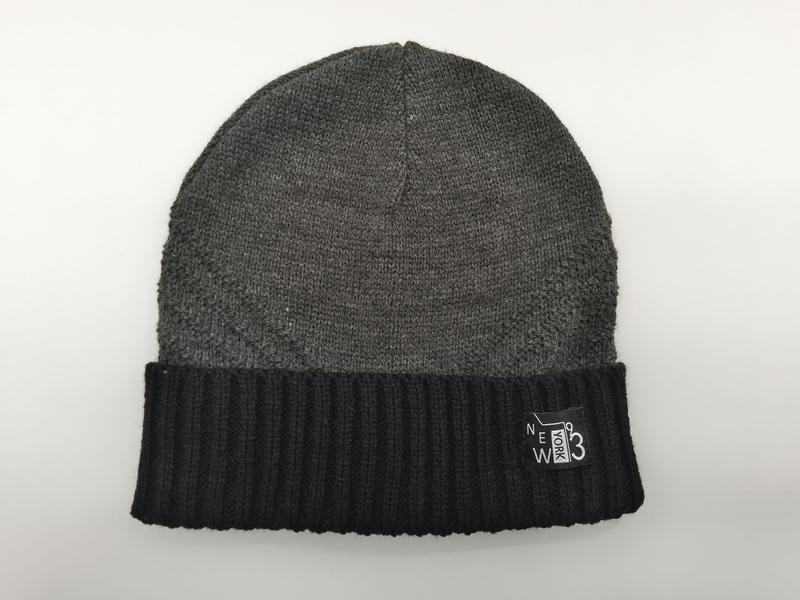 Grey knit beanie hat with black ribbed cuff and New York 93 woven label on white background - custom logo label accepted