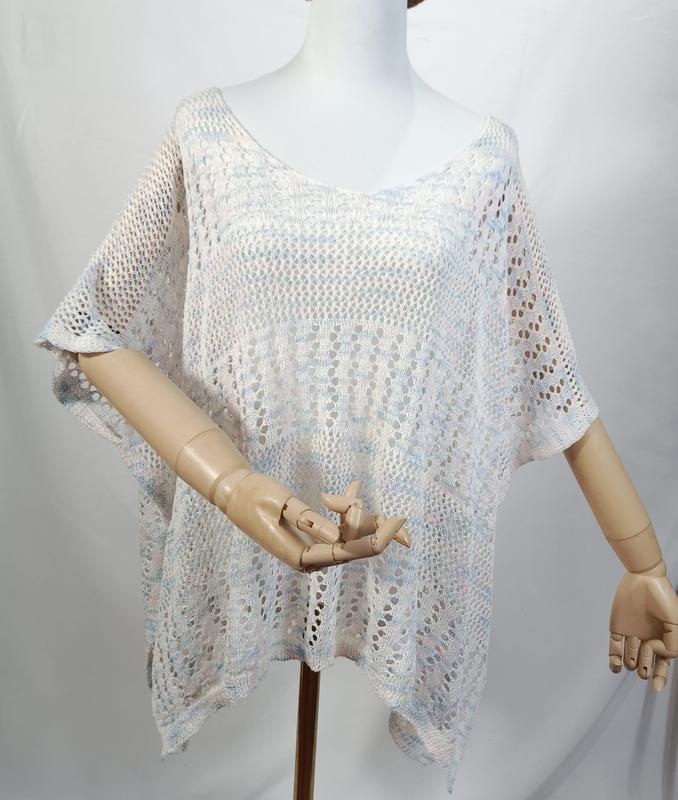 White blue multicolor open-knit crochet poncho top with short sleeves displayed on a mannequin, semi-sheer lace pattern - ask bulk pricing get discount