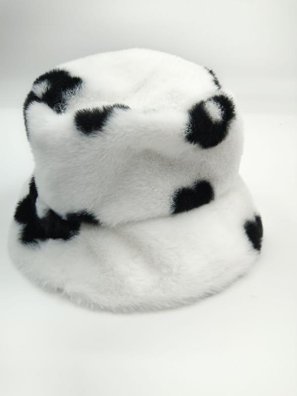 Fluffy white faux fur bucket hat with black cow spot print pattern, photographed on white background - WhatsApp quote in 2 hours