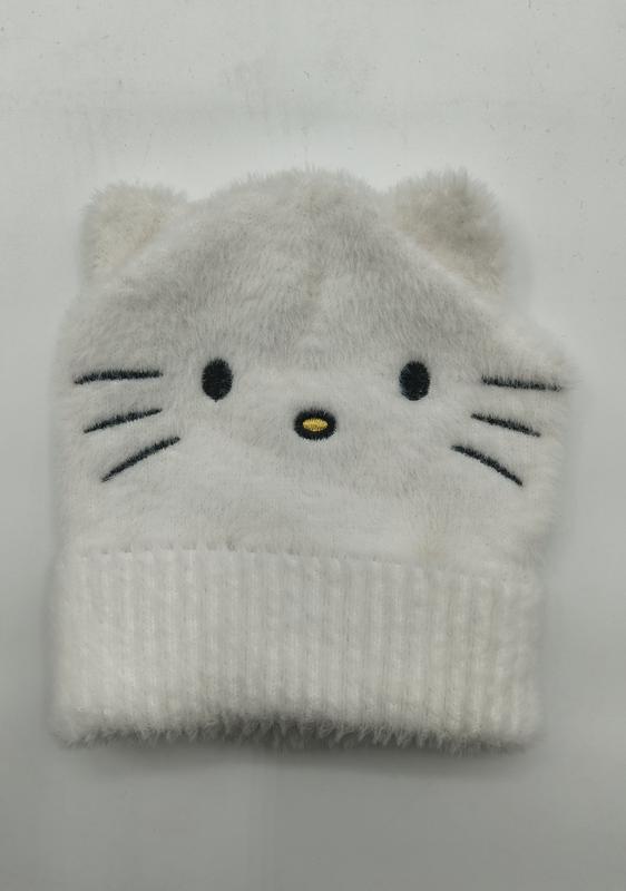 White fluffy knit beanie hat with embroidered cat face, whiskers, and small ears, folded flat on white background - boutique retail bulk order