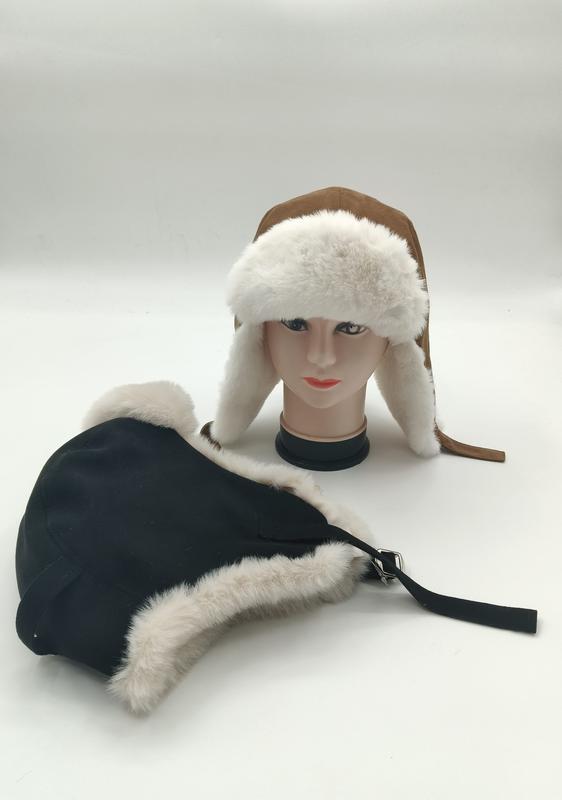 Two trapper ushanka hats with white faux fur trim displayed on mannequin head and flat surface, brown suede and black versions - ask bulk pricing get discount